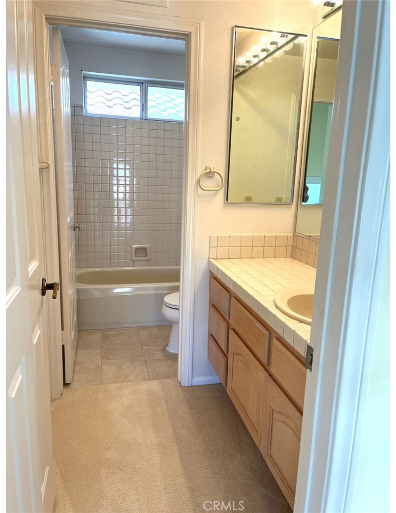 23 San Raphael Dana Point, CA 92629 - Photo 20 of 24 a bathroom with a granite countertop toilet a sink and a bathtub