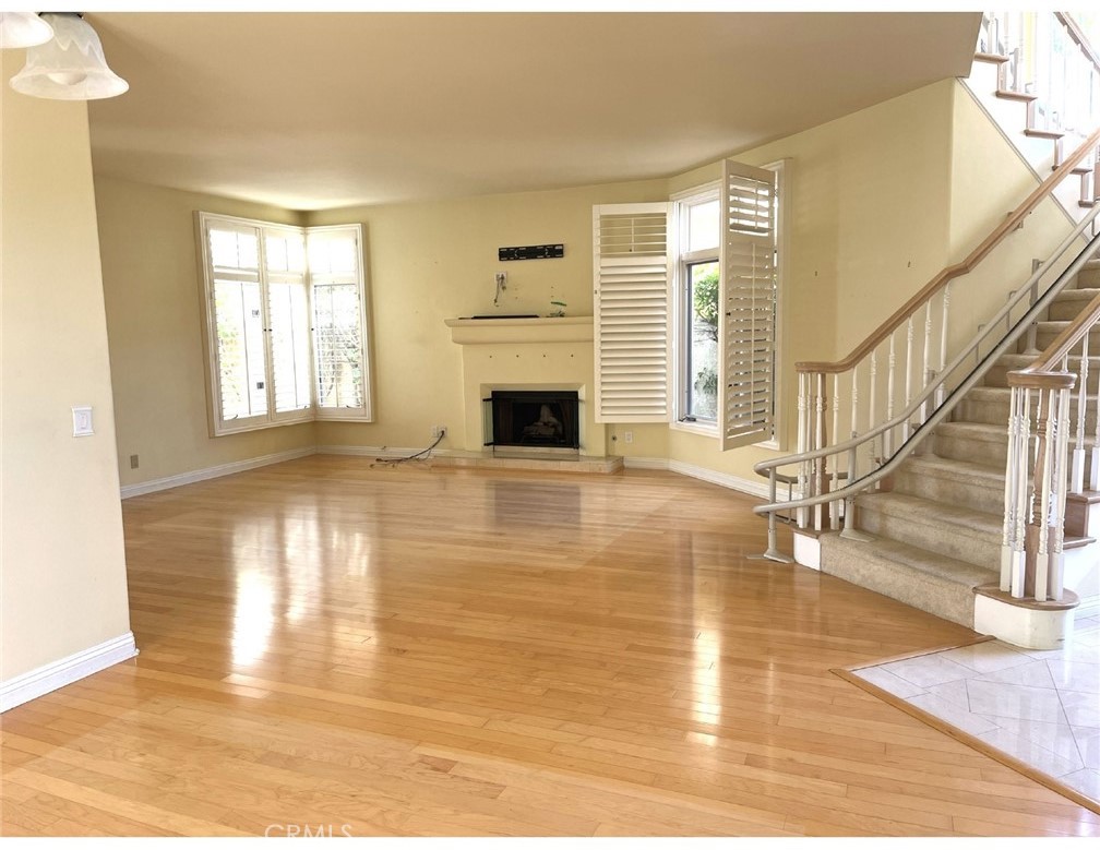 23 San Raphael Dana Point, CA 92629 - Photo 4 of 24 a view of empty room with wooden floor and fireplace