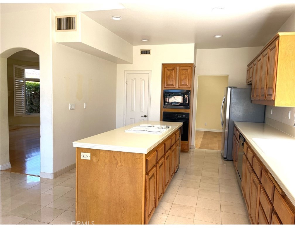 23 San Raphael Dana Point, CA 92629 - Photo 9 of 24 a kitchen with a stove and a refrigerator