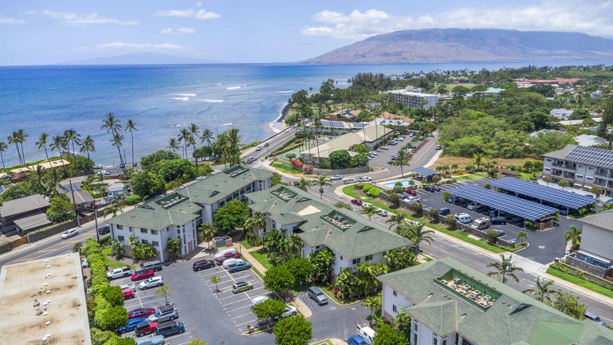 an aerial view of residential houses with outdoor space and street view