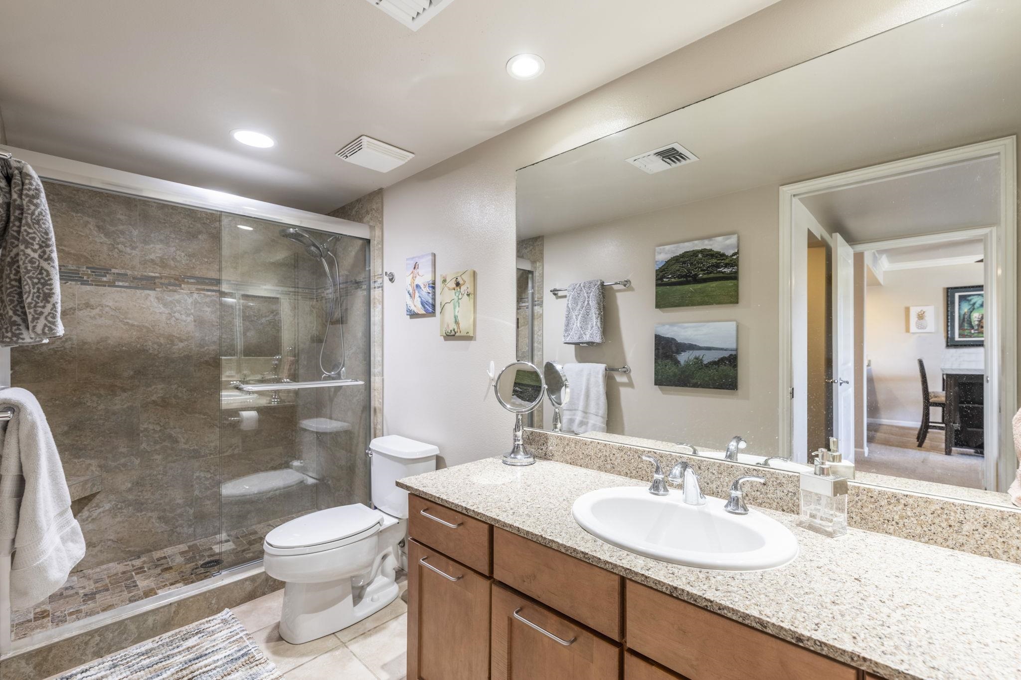 44 Kanani Road, Unit 2202 Kihei, HI 96753 - Photo 24 of 42 a bathroom with a granite countertop sink toilet and shower