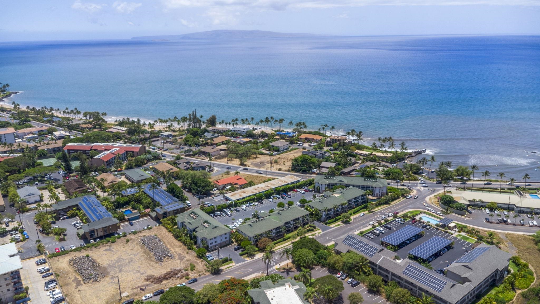 44 Kanani Road, Unit 2202 Kihei, HI 96753 - Photo 4 of 42 an aerial view of a city with lots of residential buildings and ocean view in back