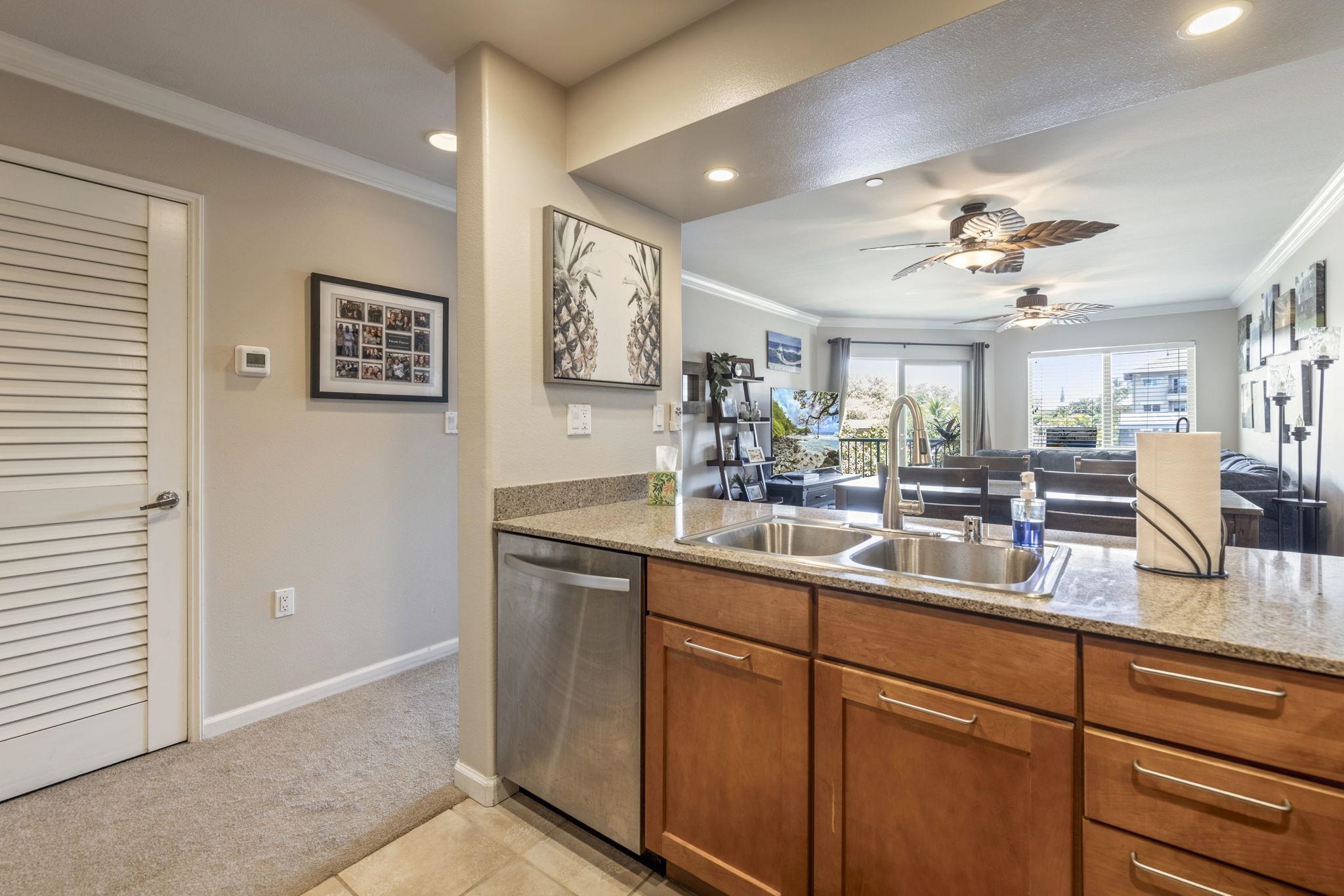 44 Kanani Road, Unit 2202 Kihei, HI 96753 - Photo 9 of 42 a kitchen with cabinets a sink and a window