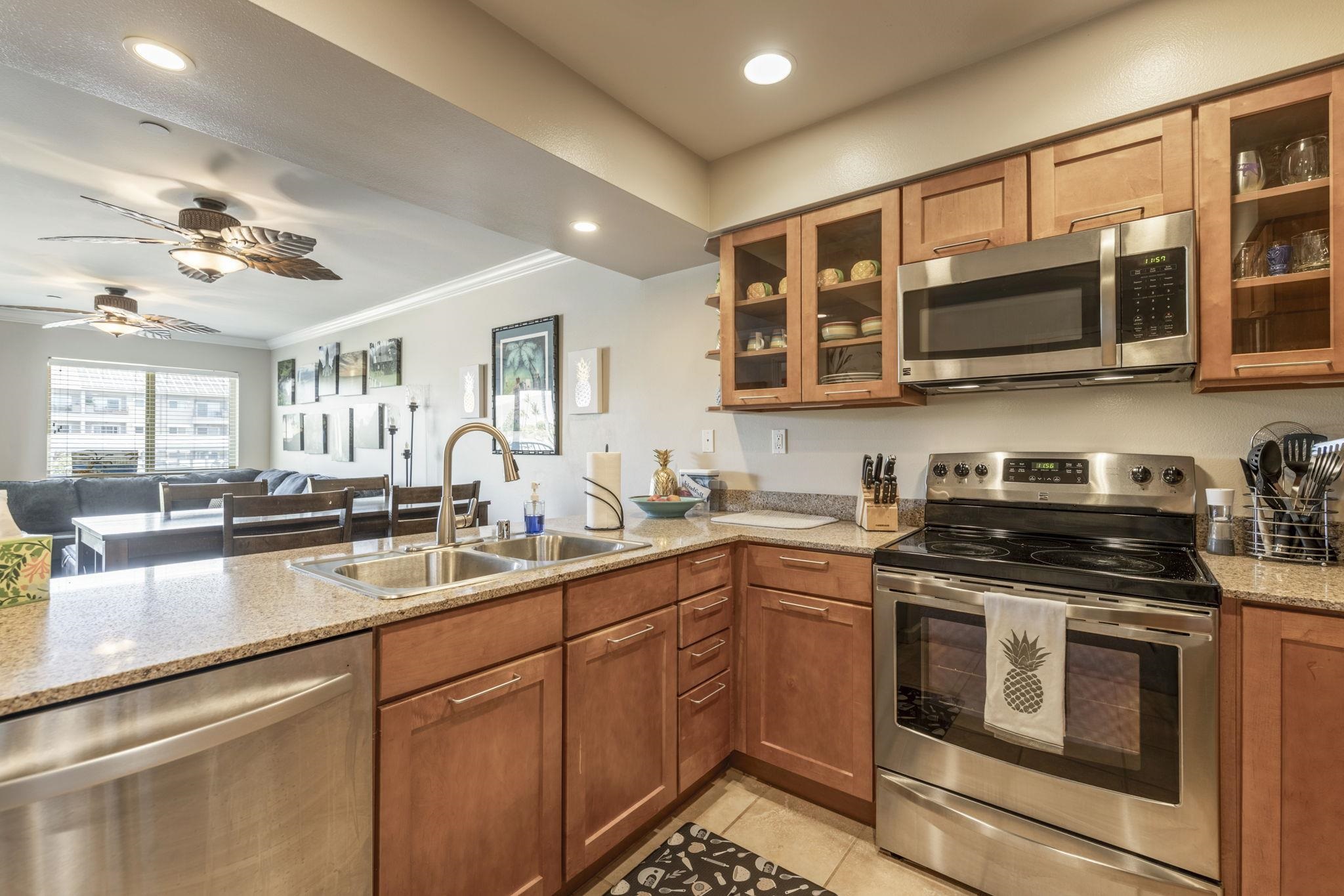 44 Kanani Road, Unit 2202 Kihei, HI 96753 - Photo 10 of 42 a kitchen with stainless steel appliances granite countertop a stove and cabinets