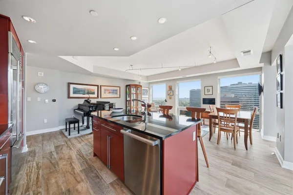 a kitchen with counter top space and wooden floor