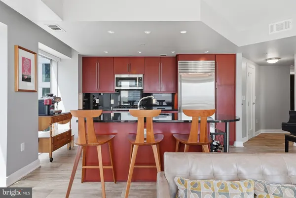a living room with lots of furniture and kitchen view