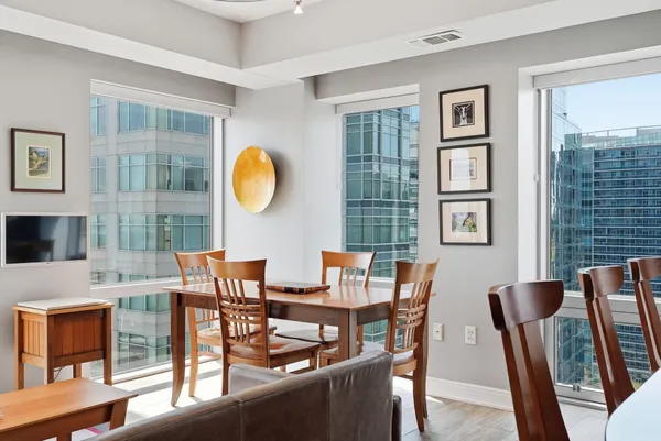 a view of a dining room with furniture and chandelier