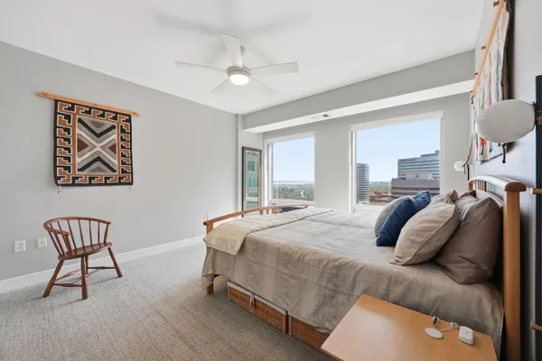 a bedroom with a bed and a chandelier