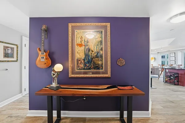 a view of a workspace with furniture and wooden floor
