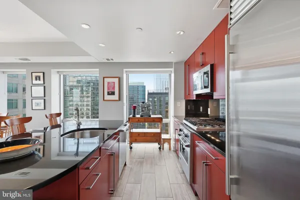 a kitchen with stainless steel appliances granite countertop a stove and a sink