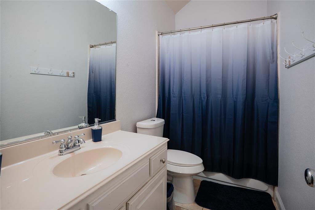 1444 Mercury Lane Lancaster, TX 75134 - Photo 14 of 19 a bathroom with a sink and a toilet