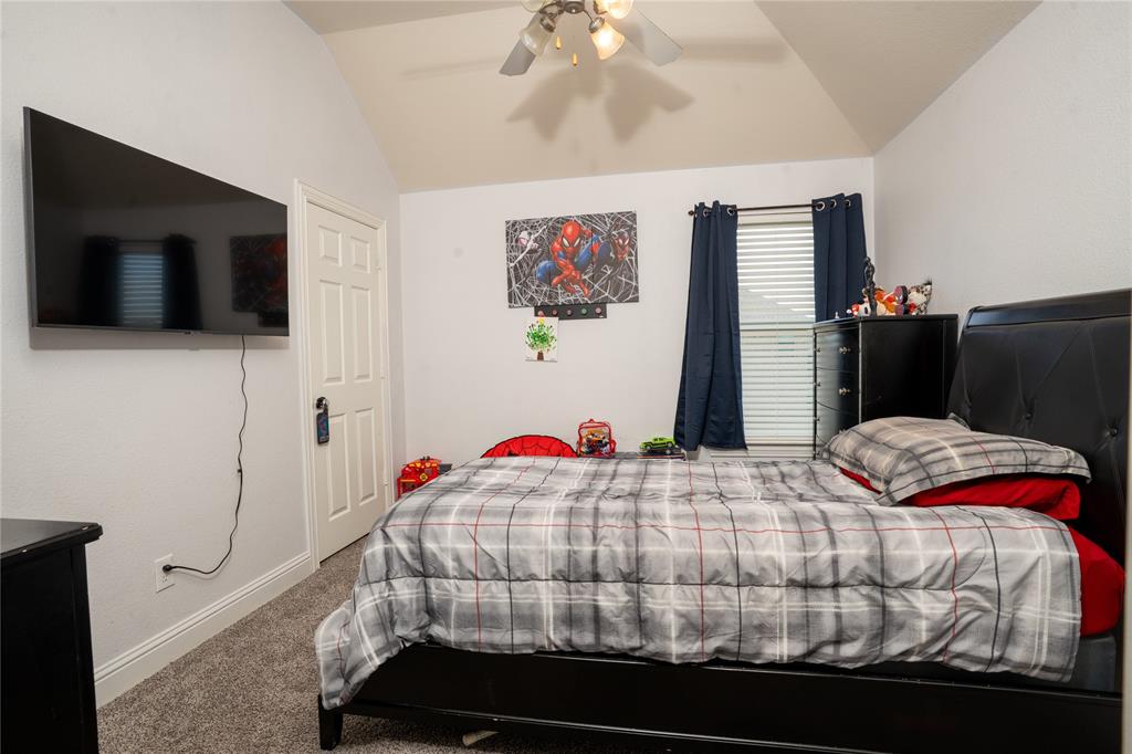 1444 Mercury Lane Lancaster, TX 75134 - Photo 17 of 19 a bedroom with a bed and a flat screen tv