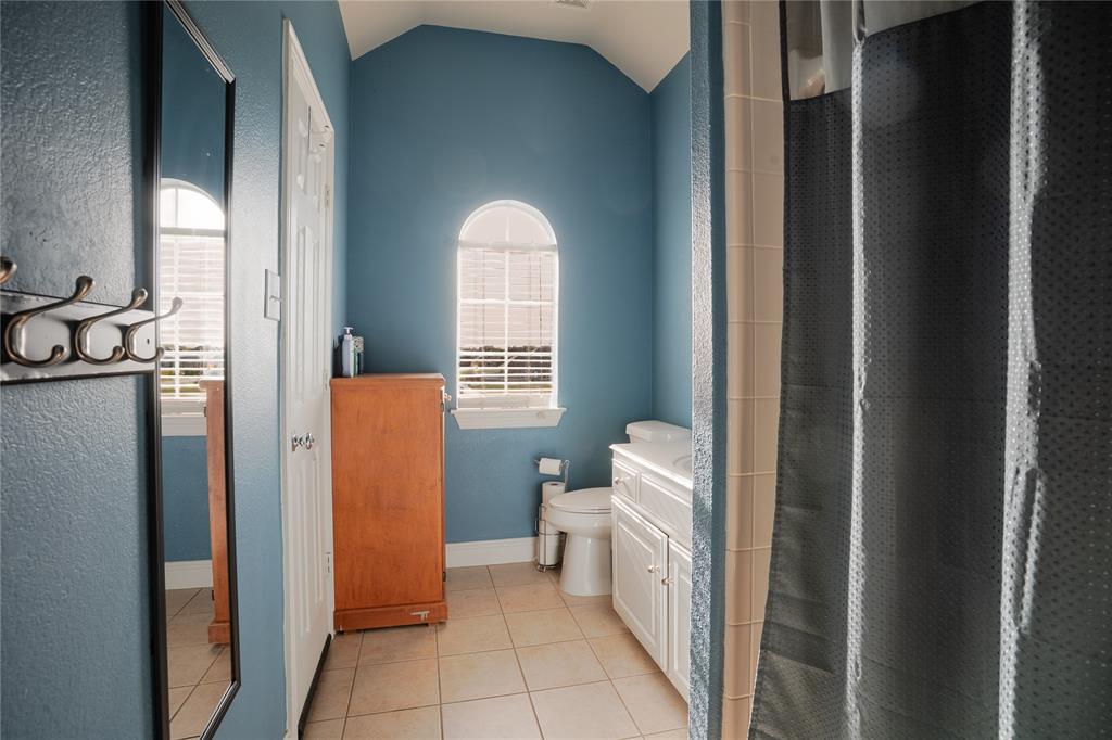 1444 Mercury Lane Lancaster, TX 75134 - Photo 3 of 19 a bathroom with a toilet a sink and a mirror