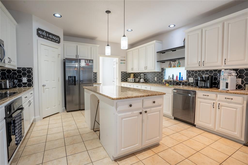 1444 Mercury Lane Lancaster, TX 75134 - Photo 7 of 19 a kitchen with white cabinets and white appliances