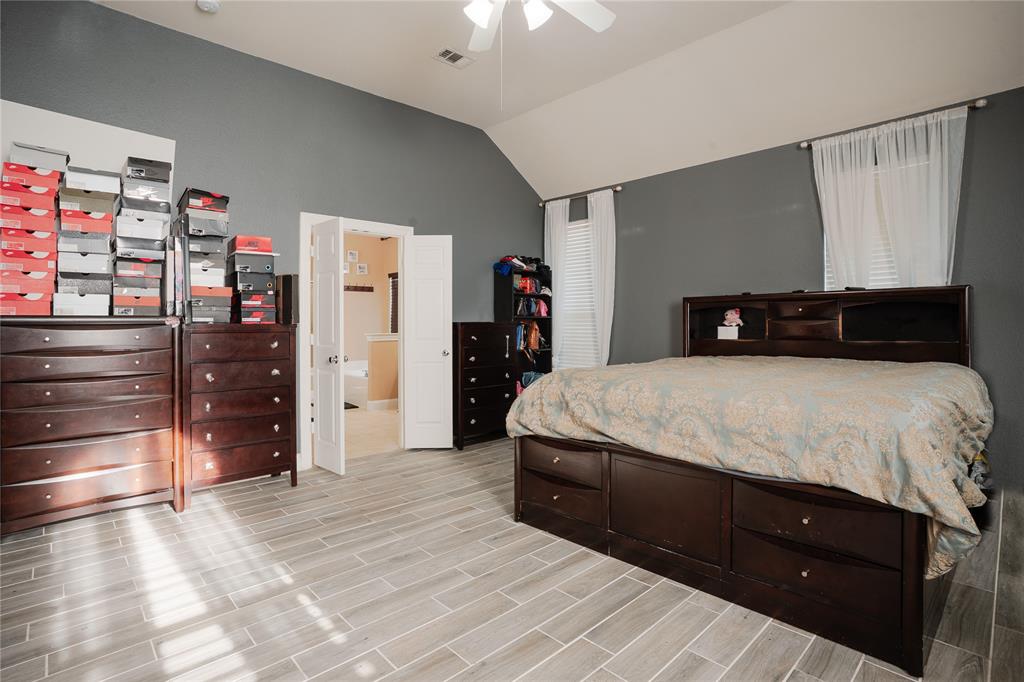 1444 Mercury Lane Lancaster, TX 75134 - Photo 10 of 19 a bedroom with a bed and a walk in closet