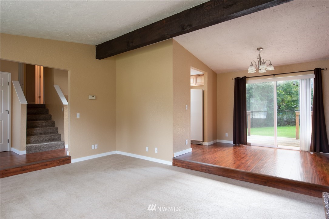 220 154th Place Southeast Bothell, WA 98012 - Photo 2 of 25 a view of a room with wooden floor and window