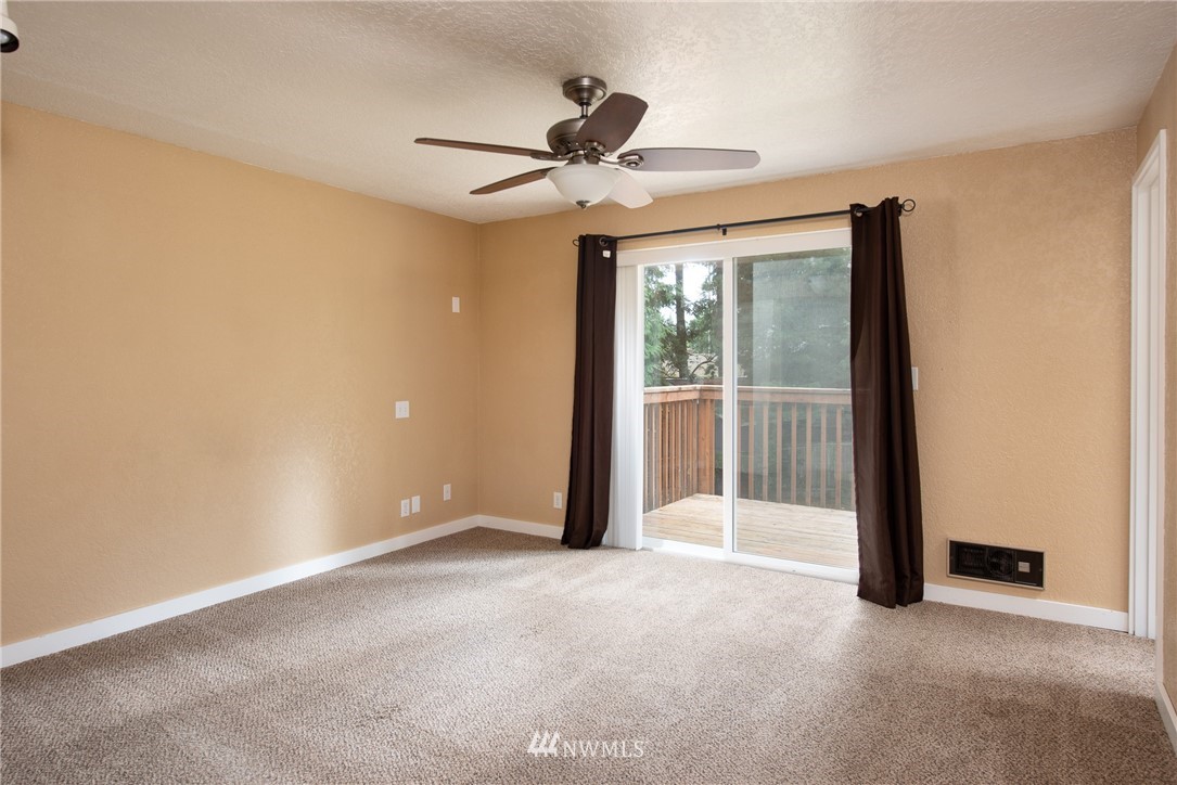 220 154th Place Southeast Bothell, WA 98012 - Photo 13 of 25 a view of empty room with wooden floor and fan