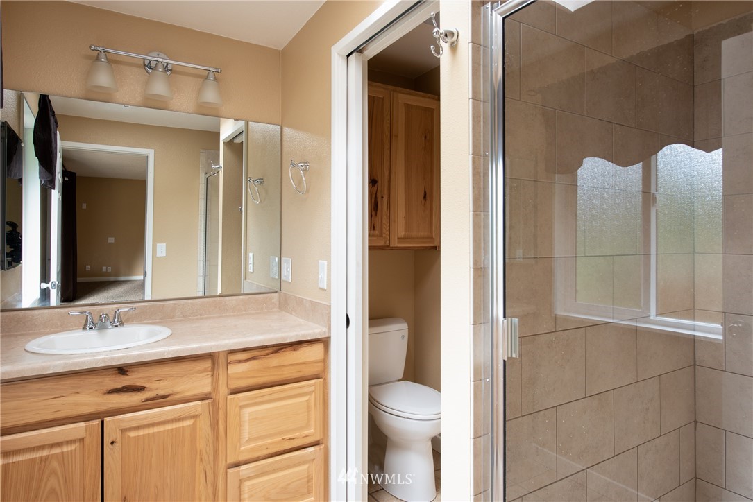 220 154th Place Southeast Bothell, WA 98012 - Photo 15 of 25 a bathroom with a granite countertop sink toilet and shower