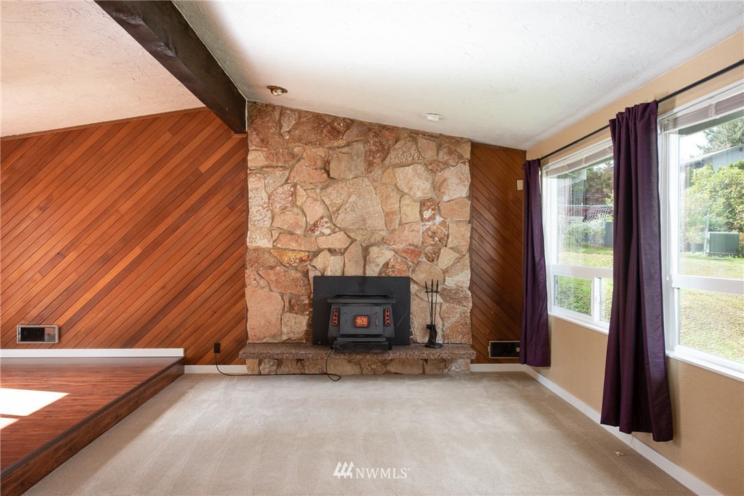 220 154th Place Southeast Bothell, WA 98012 - Photo 3 of 25 a view of an empty room with fireplace and a window