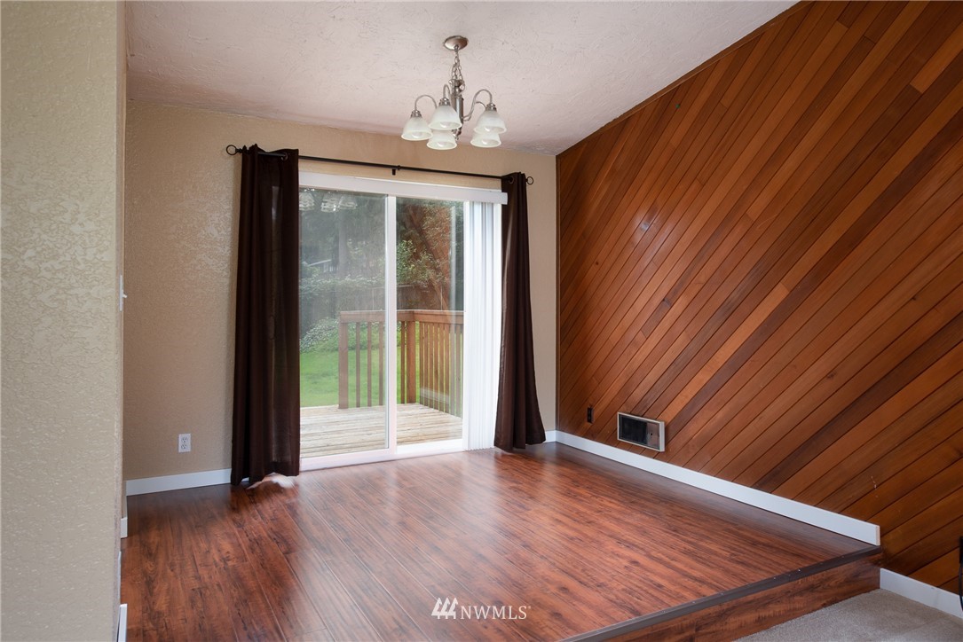 220 154th Place Southeast Bothell, WA 98012 - Photo 4 of 25 a view of an empty room with wooden floor and a window