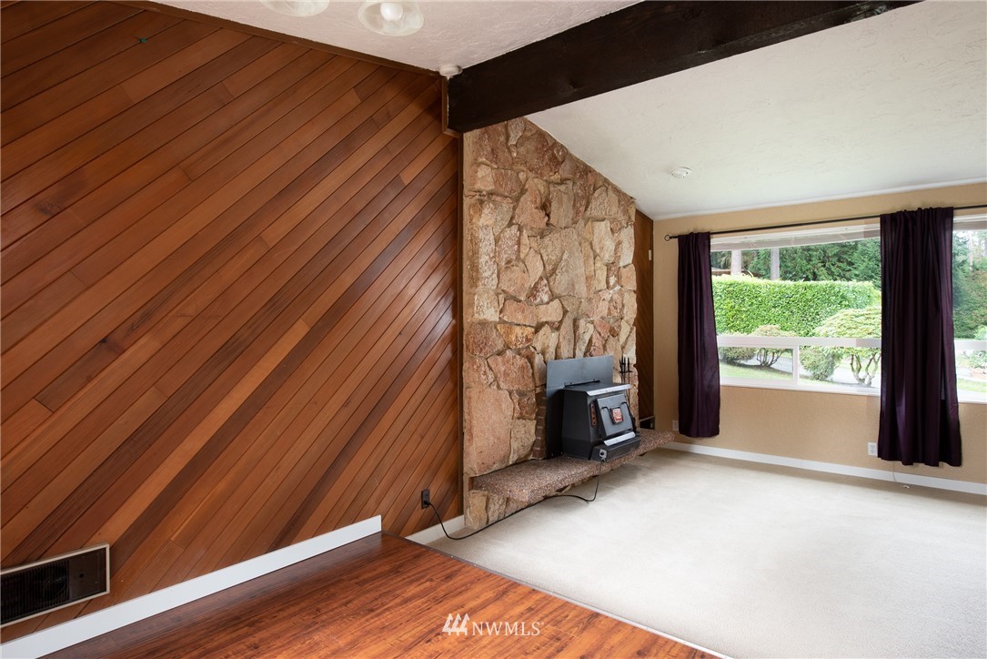 220 154th Place Southeast Bothell, WA 98012 - Photo 5 of 25 a view of an empty room with a fireplace and a window