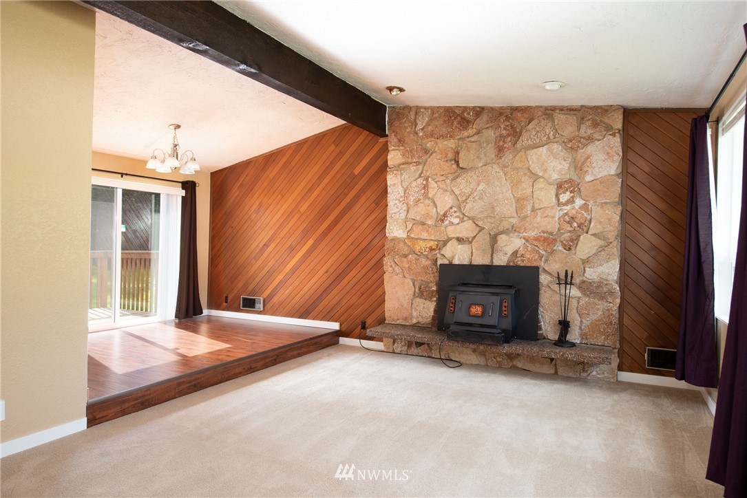 220 154th Place Southeast Bothell, WA 98012 - Photo 6 of 25 a living room with a fireplace furniture and a fireplace
