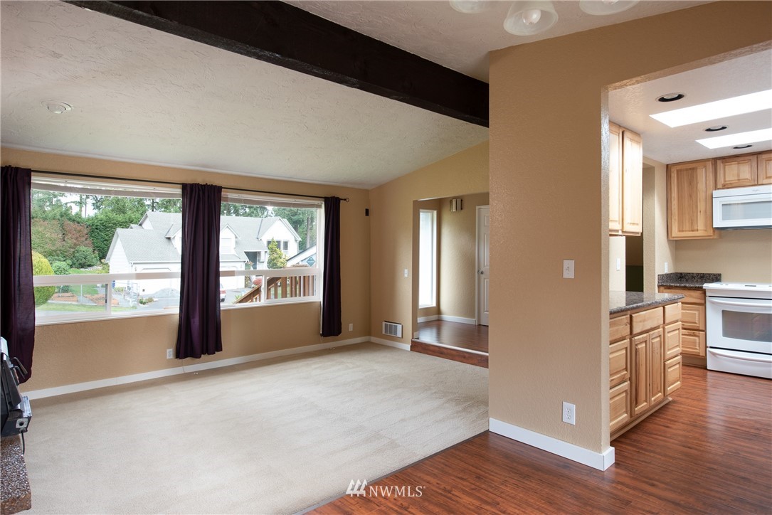 220 154th Place Southeast Bothell, WA 98012 - Photo 7 of 25 a living room with stainless steel appliances granite countertop furniture and a large window