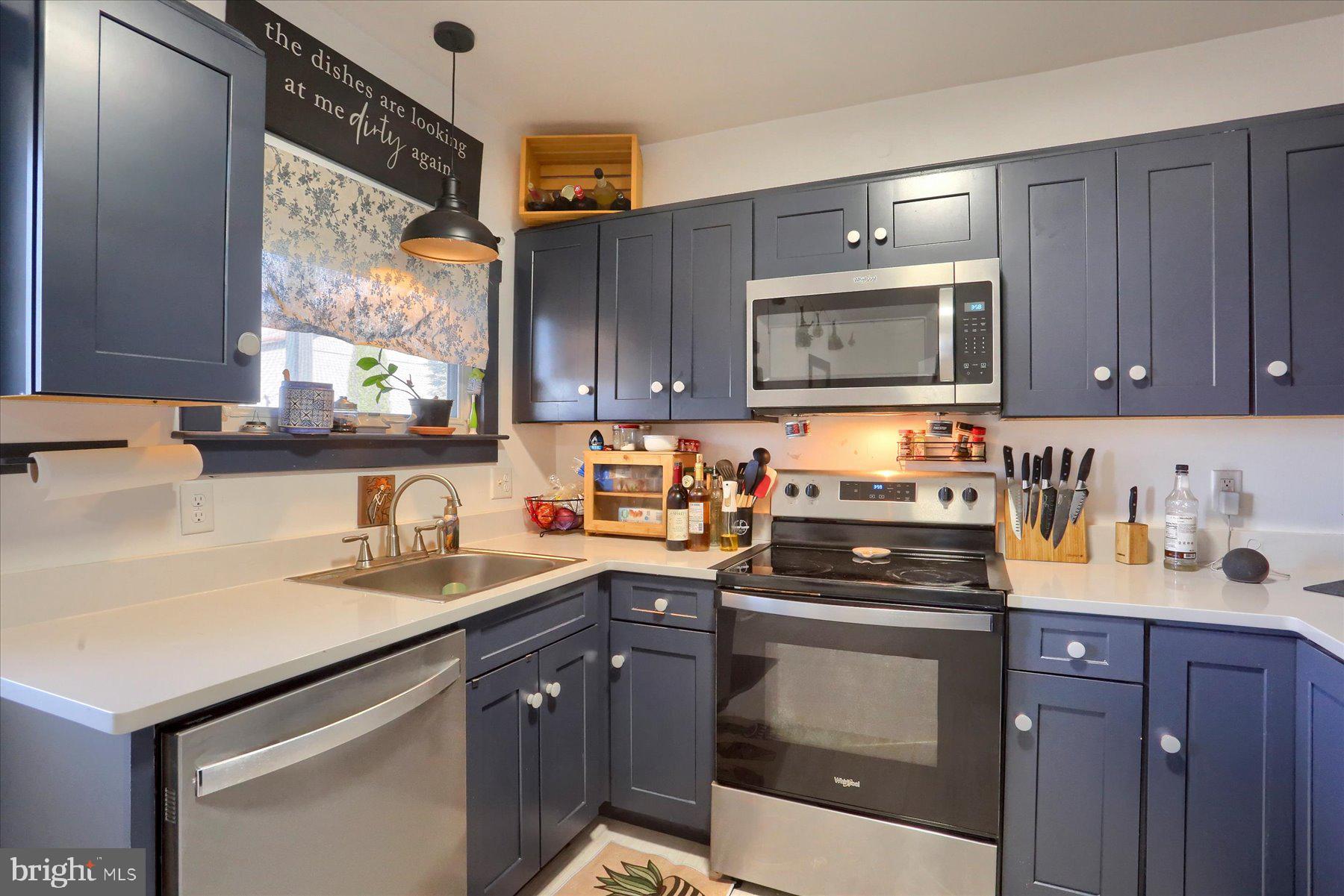 206 Armstrong Street Halifax, PA 17032 - Photo 13 of 20 a kitchen with granite countertop a sink stove and microwave