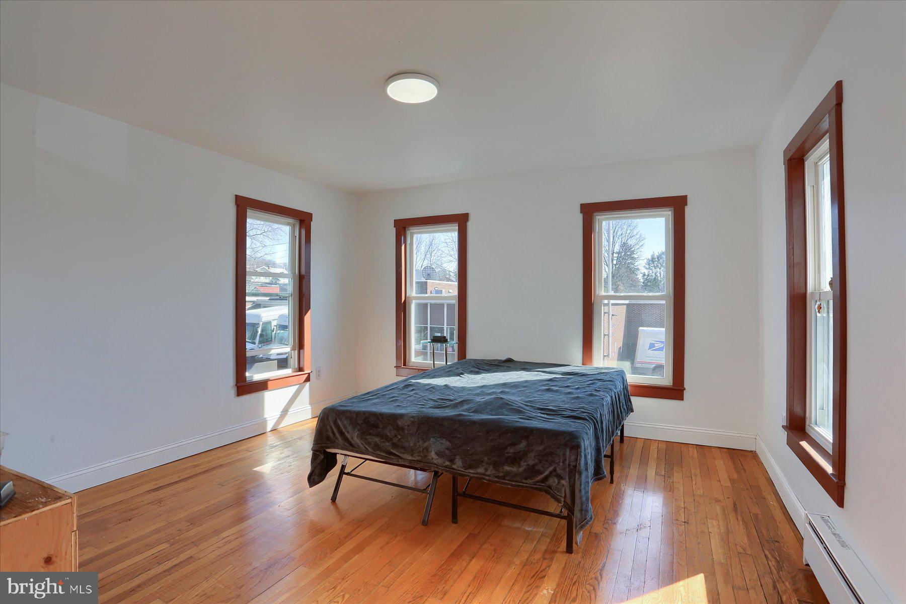 206 Armstrong Street Halifax, PA 17032 - Photo 16 of 20 a bedroom with a bed and wooden floor