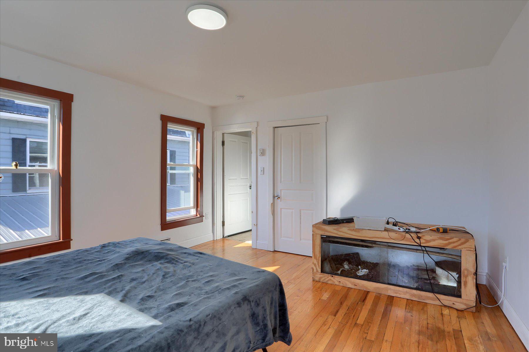 206 Armstrong Street Halifax, PA 17032 - Photo 17 of 20 a bedroom with a bed and a wooden floor