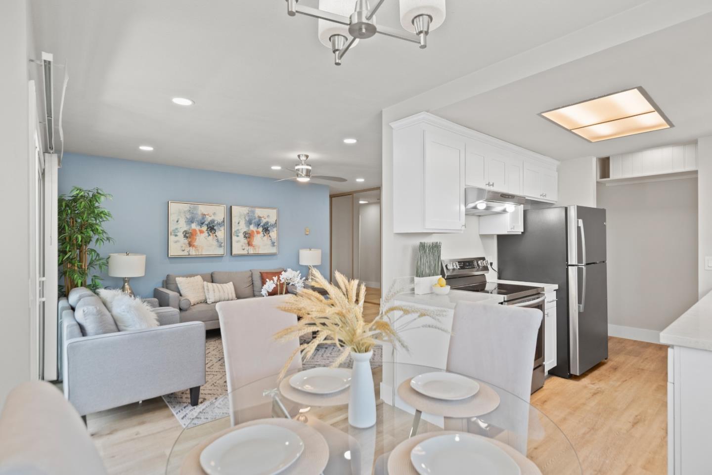 1135 Reed Avenue, Unit D Sunnyvale, CA 94086 - Photo 1 of 24 a living room with furniture a large window and kitchen view