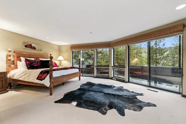 a bathroom with a double vanity sink a toilet a mirror and shower