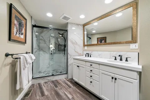 a bedroom with a bed and a lamp next to a window