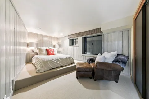 a bedroom with two beds and painting on the wall