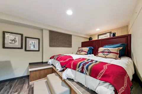 a bed room with a bed and a television