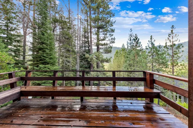 a view of a balcony with table and chairs