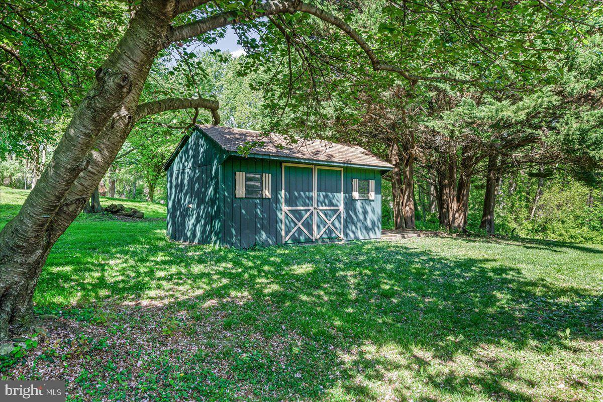322 Buttonwood Road Landenberg, PA 19350 - Photo 49 of 60 Charming shed nestled in lush greenery.