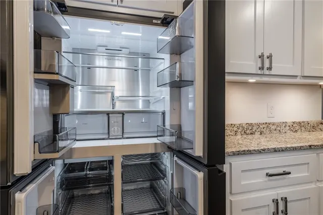 a spacious bedroom with a bed and a ceiling fan