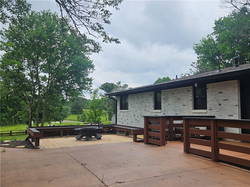 9351 Henderson Mountain Road Fairmount, GA 30139 - Photo 3 of 60 a backyard of a house with barbeque oven and outdoor seating