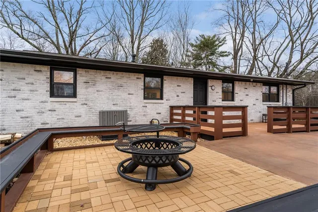 a view of a park with swings and a bench