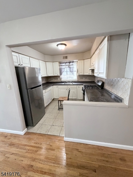 1036 Flora Street, Unit 1 Elizabeth, NJ 07201 - Photo 4 of 10 a living room with stainless steel appliances granite countertop furniture a refrigerator and wooden floor