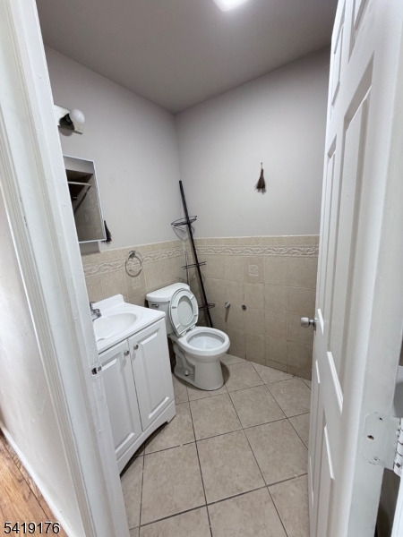 1036 Flora Street, Unit 1 Elizabeth, NJ 07201 - Photo 6 of 10 a bathroom with a sink a toilet and a shower