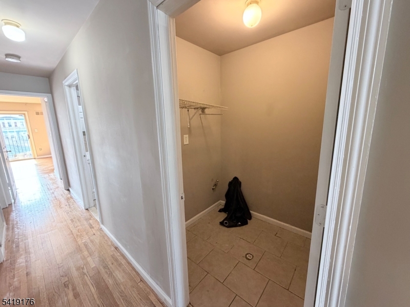 1036 Flora Street, Unit 1 Elizabeth, NJ 07201 - Photo 9 of 10 a view of a bathroom from a hallway