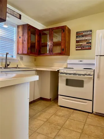 a kitchen with a sink cabinets and appliances