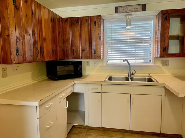 a room with table chairs and wooden floor