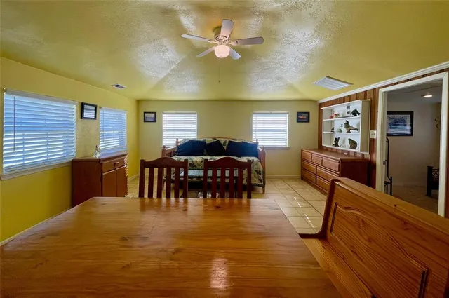 a dining room with furniture and a kitchen view