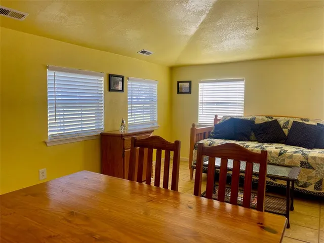 a living room with lots of furniture and black appliances