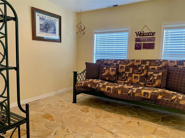 a bedroom with a couch and a window