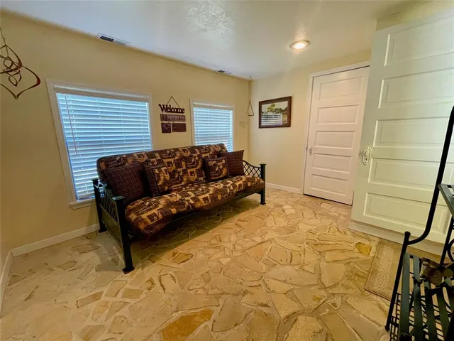 a view of a hallway with wooden floor and closet