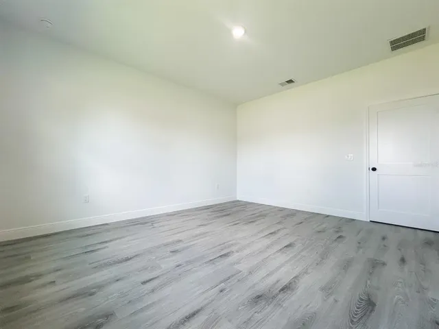 a view of a room with wooden floor